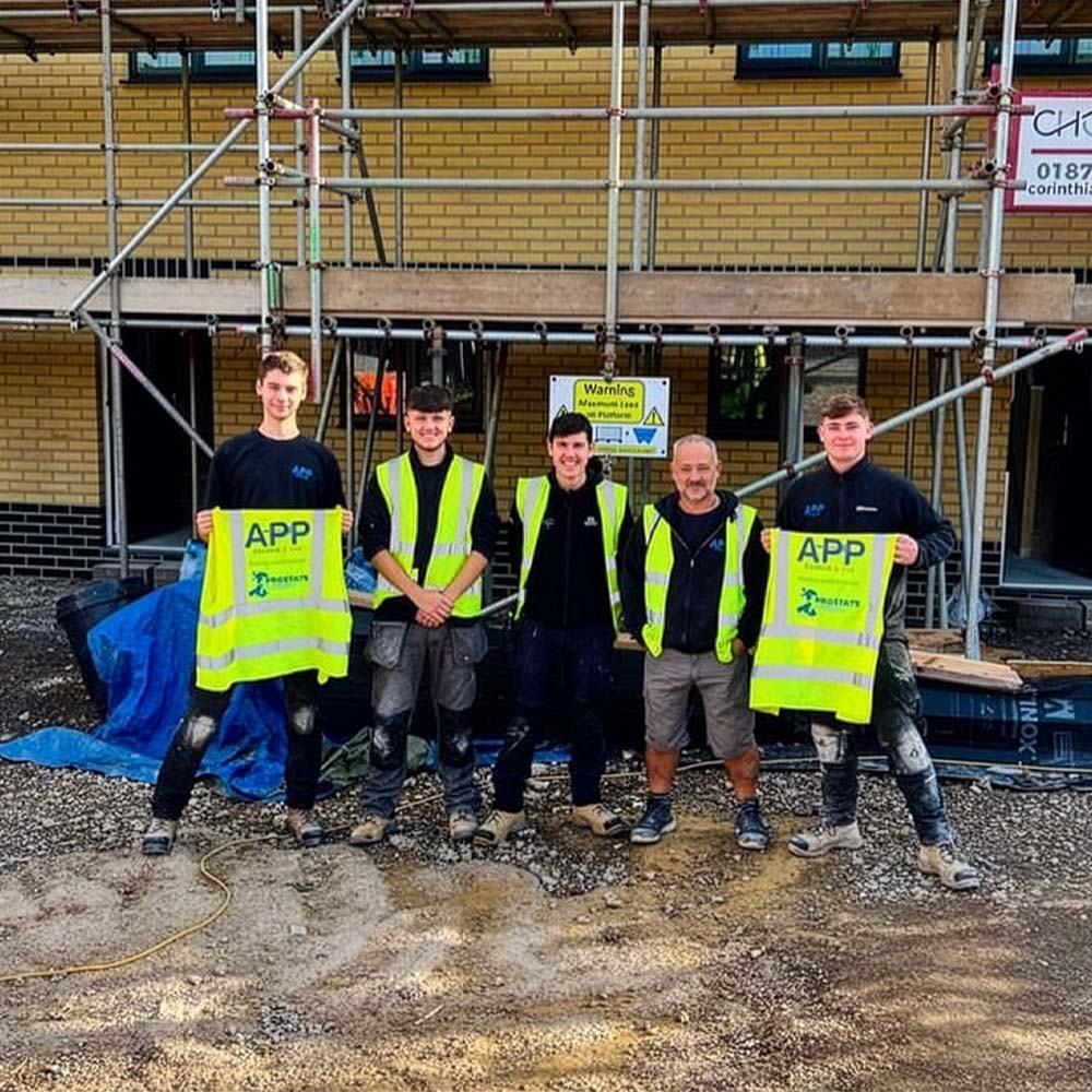 APP Electrical team stood together outside of commercial property.