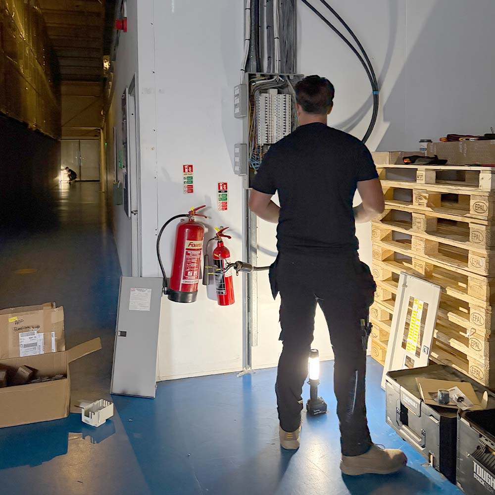 APP Electrical team member fixing power cut at commercial warehouse in south wales.
