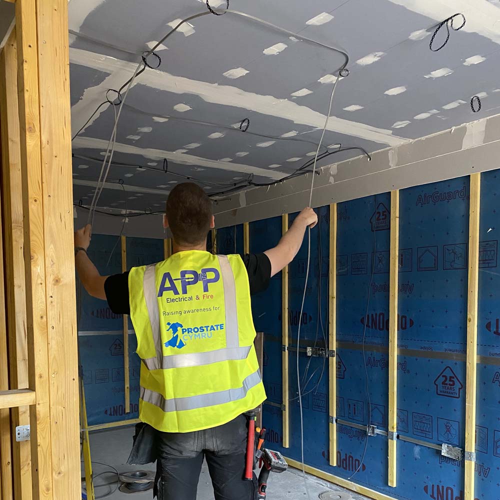 APP Electrical team member carrying out electrical works inside of a domestic property.