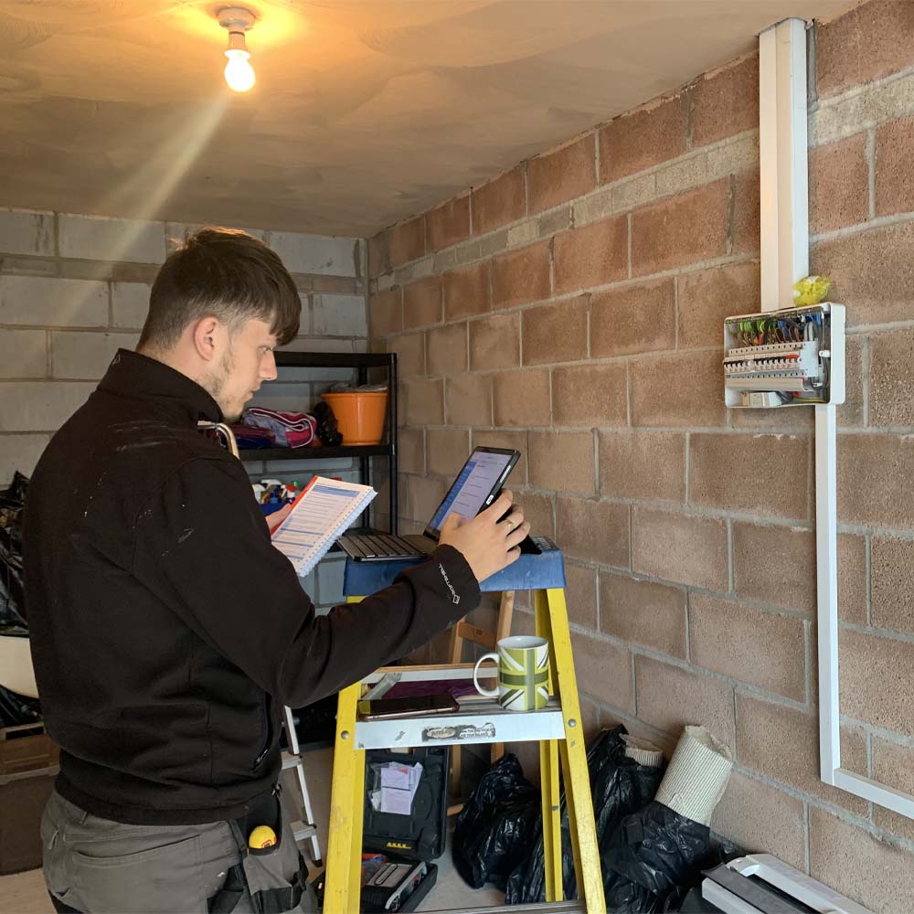 APP Electrical team member carrying out tests after installing new consumer unit fuse box.