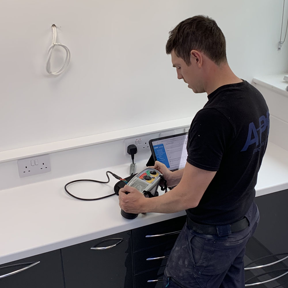 Andrew from APP Electrical testing a kitchen plug socket after rewire.
