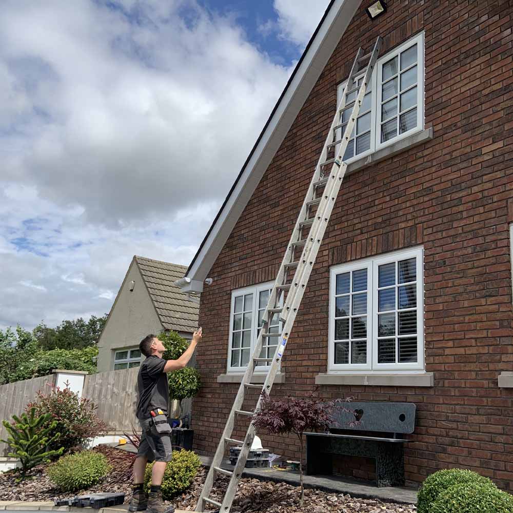 Andrew from APP Electrical installing security lighting for homeowner in south wales.